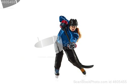 Image of Young female hockey player with the stick on ice court and white background