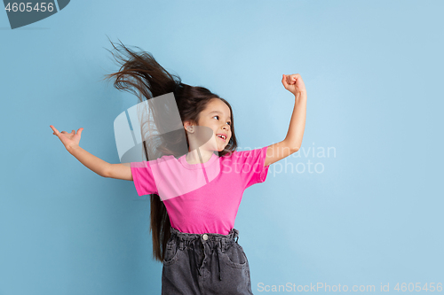 Image of Caucasian little girl\'s portrait on blue studio background