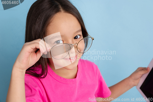 Image of Caucasian little girl\'s portrait on blue studio background