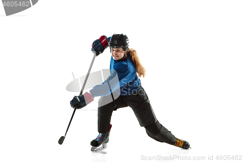 Image of Young female hockey player with the stick on ice court and white background