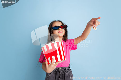 Image of Caucasian little girl\'s portrait on blue studio background