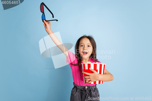 Image of Caucasian little girl\'s portrait on blue studio background