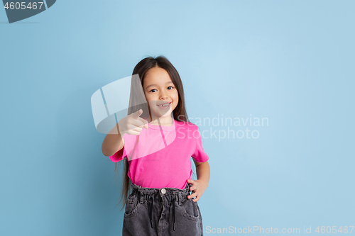 Image of Caucasian little girl\'s portrait on blue studio background