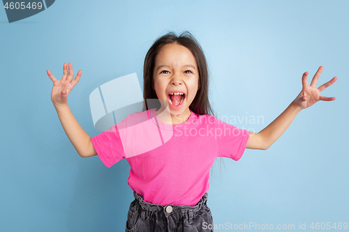 Image of Caucasian little girl\'s portrait on blue studio background