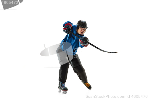 Image of Young female hockey player with the stick on ice court and white background