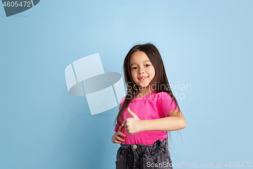 Image of Caucasian little girl\'s portrait on blue studio background