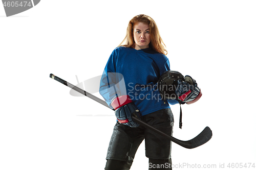 Image of Young female hockey player with the stick on ice court and white background