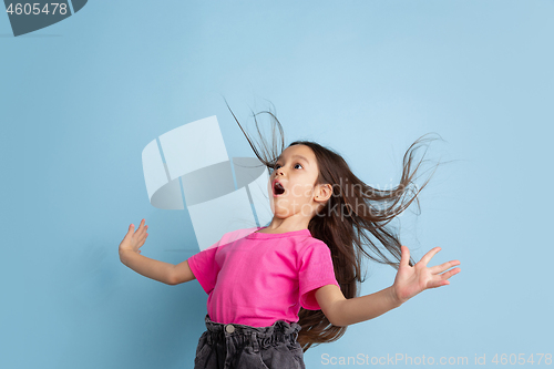 Image of Caucasian little girl\'s portrait on blue studio background