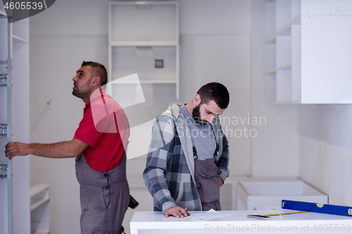 Image of workers installing a new kitchen