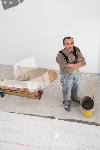 Image of worker installing the ceramic wood effect tiles on the floor