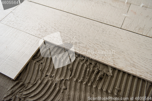 Image of Ceramic wood effect tiles and tools for tiler on the floor