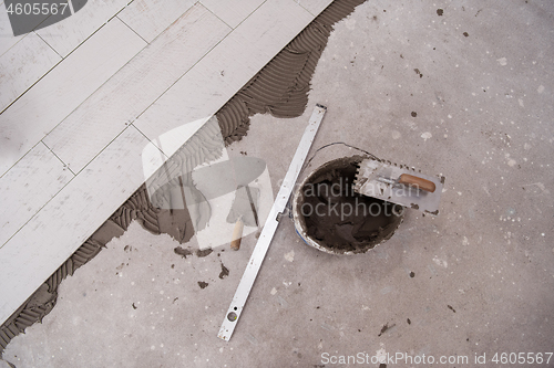 Image of Ceramic wood effect tiles and tools for tiler on the floor