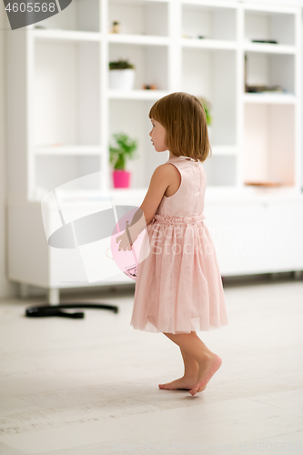 Image of cute little girl playing with balloons