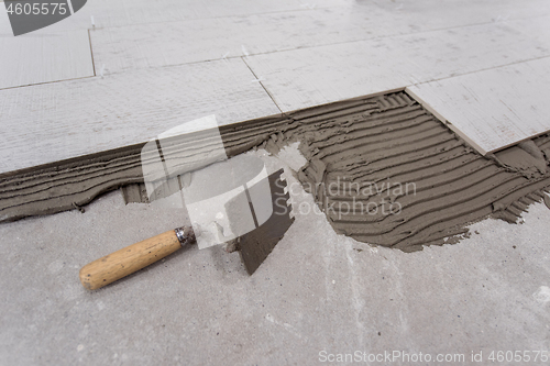 Image of Ceramic wood effect tiles and tools for tiler on the floor