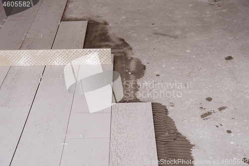 Image of Ceramic wood effect tiles and tools for tiler on the floor