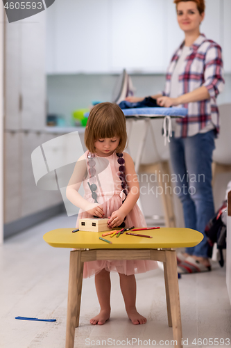 Image of mother and daughter spending time together at home