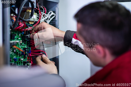 Image of electrician engineer working with electric cable wires