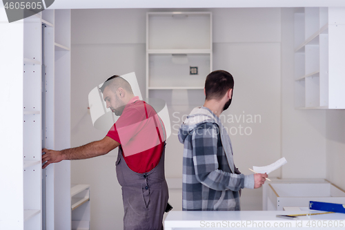 Image of workers installing a new kitchen
