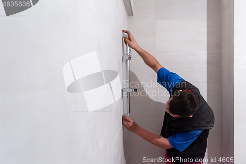 Image of professional plumber working in a bathroom