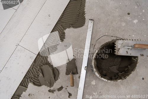 Image of Ceramic wood effect tiles and tools for tiler on the floor