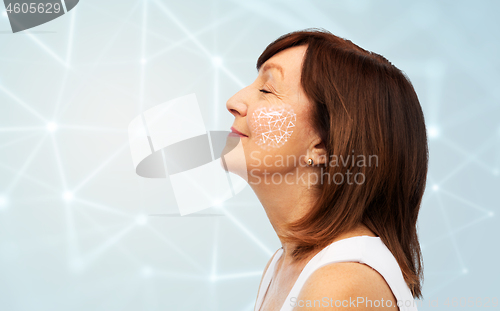 Image of senior woman with low poly grid on her cheek