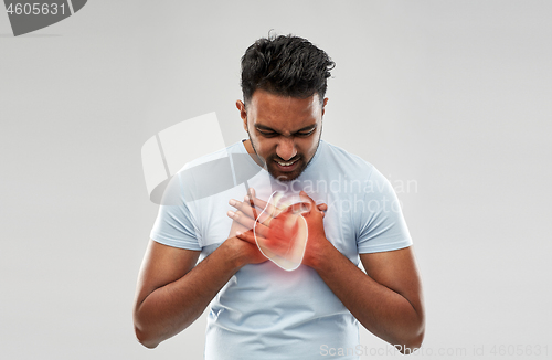 Image of unhappy man having heart attack or heartache