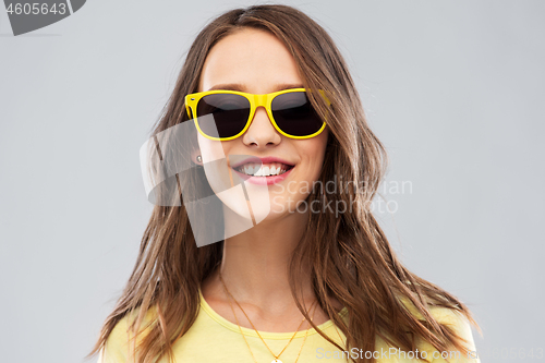 Image of teenage girl in yellow sunglasses and t-shirt