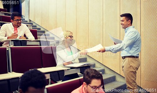 Image of teacher giving tests to students at lecture