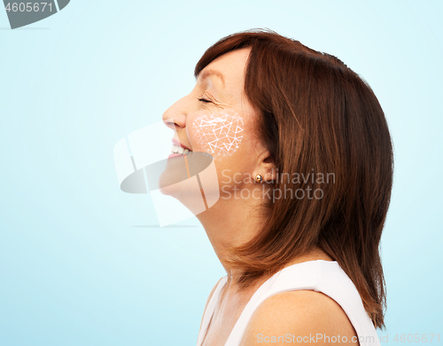 Image of profile of smiling senior woman over white