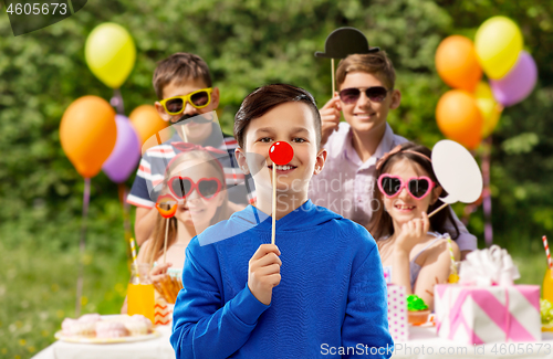 Image of happy boy with red clown nose at birthday party