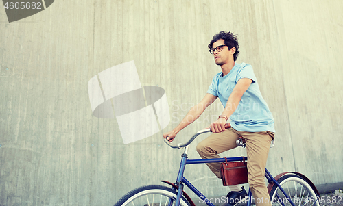 Image of young hipster man riding fixed gear bike