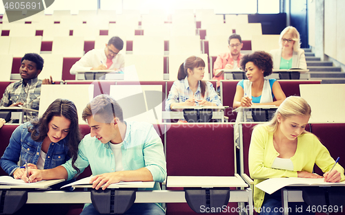 Image of group of students with notebooks at lecture hall