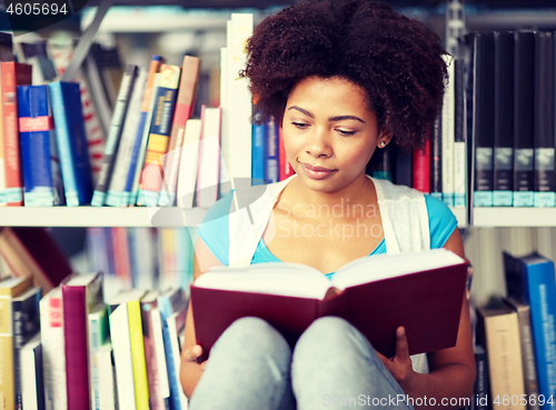 Image of african student girl reading book at library