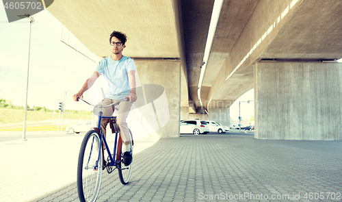 Image of young hipster man riding fixed gear bike