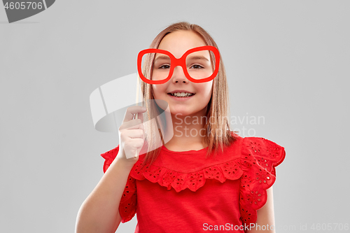 Image of beautiful smiling girl with big paper glasses