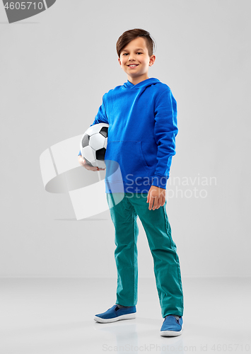 Image of smiling boy in blue hoodie with soccer ball