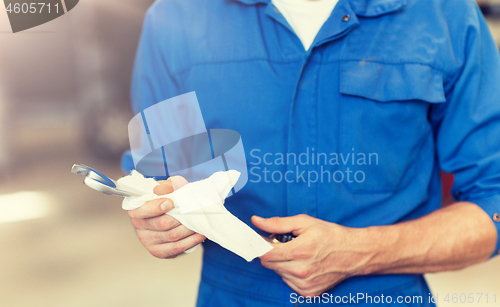 Image of auto mechanic or smith with wrench at car workshop