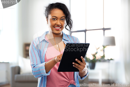 Image of happy african american woman using tablet pc