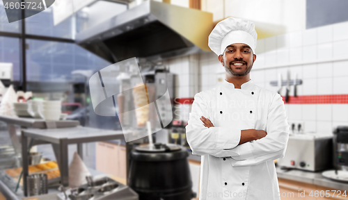 Image of happy male indian chef in toque at kebab shop