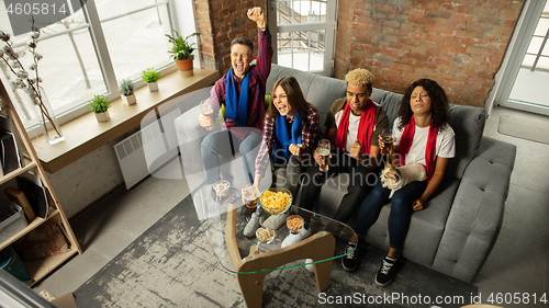 Image of Excited group of people watching sport match, championship at home