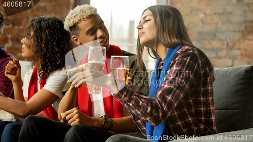 Image of Excited group of people watching sport match, championship at home