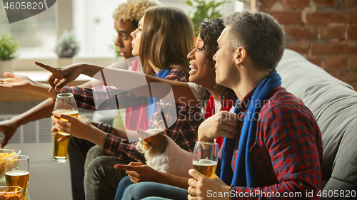 Image of Excited group of people watching sport match, championship at home