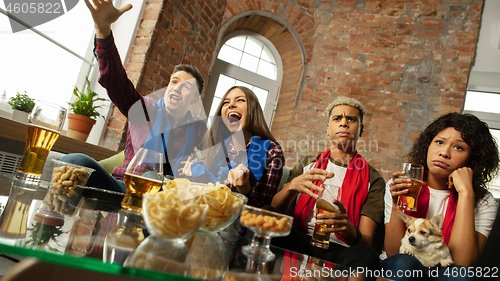 Image of Excited group of people watching sport match, championship at home