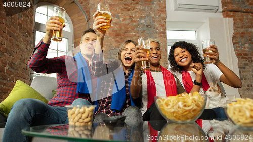 Image of Excited group of people watching sport match, championship at home