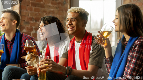 Image of Excited group of people watching sport match, championship at home