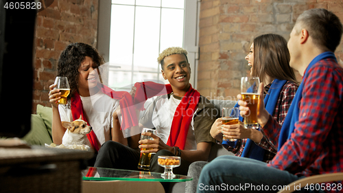 Image of Excited group of people watching sport match, championship at home