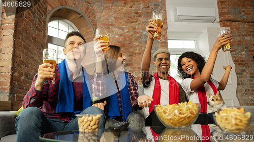 Image of Excited group of people watching sport match, championship at home