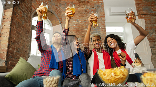 Image of Excited group of people watching sport match, championship at home