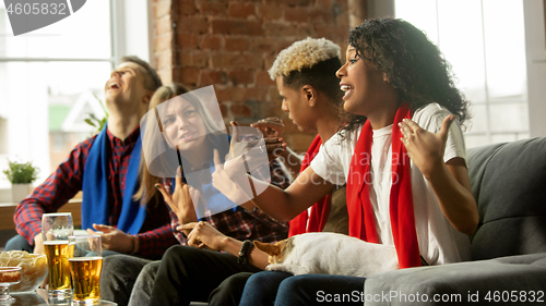 Image of Excited group of people watching sport match, championship at home