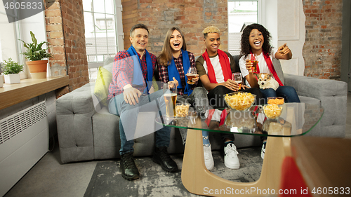 Image of Excited group of people watching sport match, championship at home